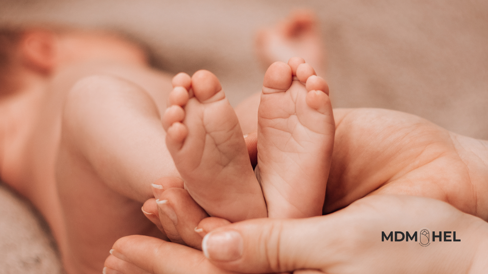 woman-holding-baby-feet Woman holding baby feet