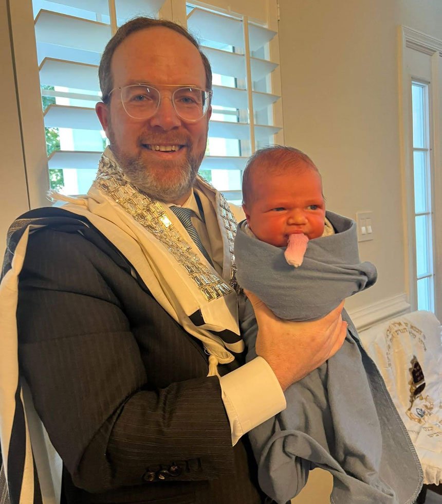 rabbi holding a baby