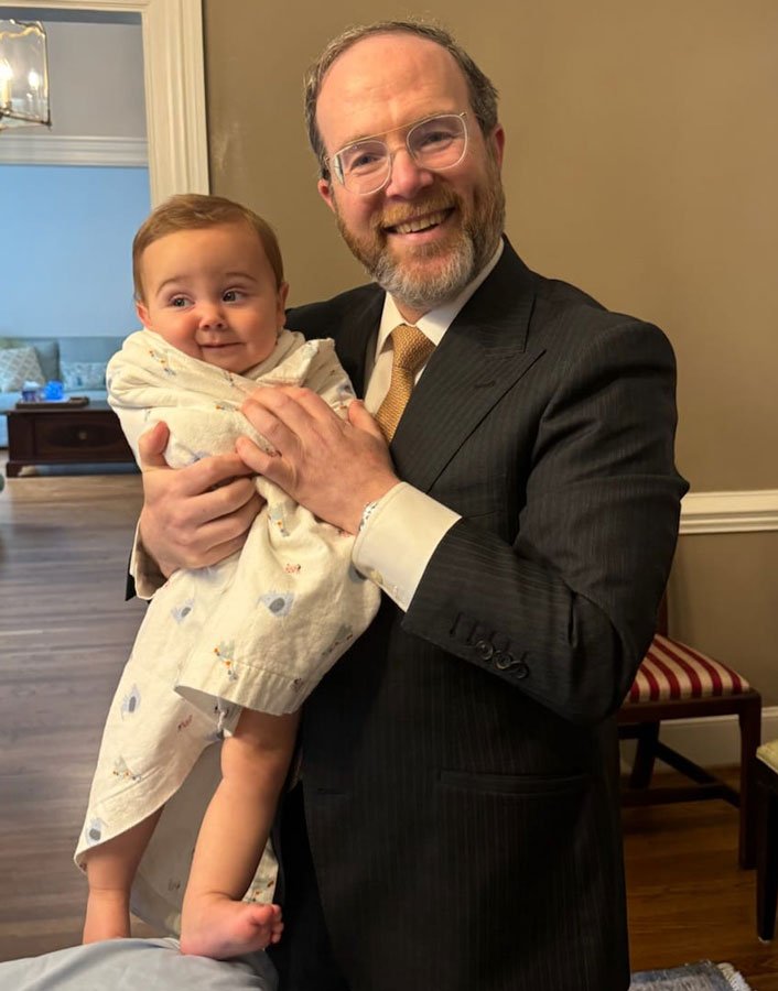rabbi holding newborn boy